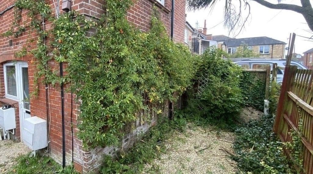 Before: side passage cleared in Southbourne