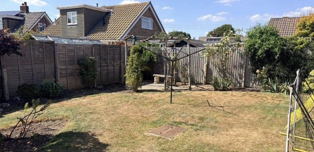 Family garden with borders cleared, lawn cut and fence line opened up